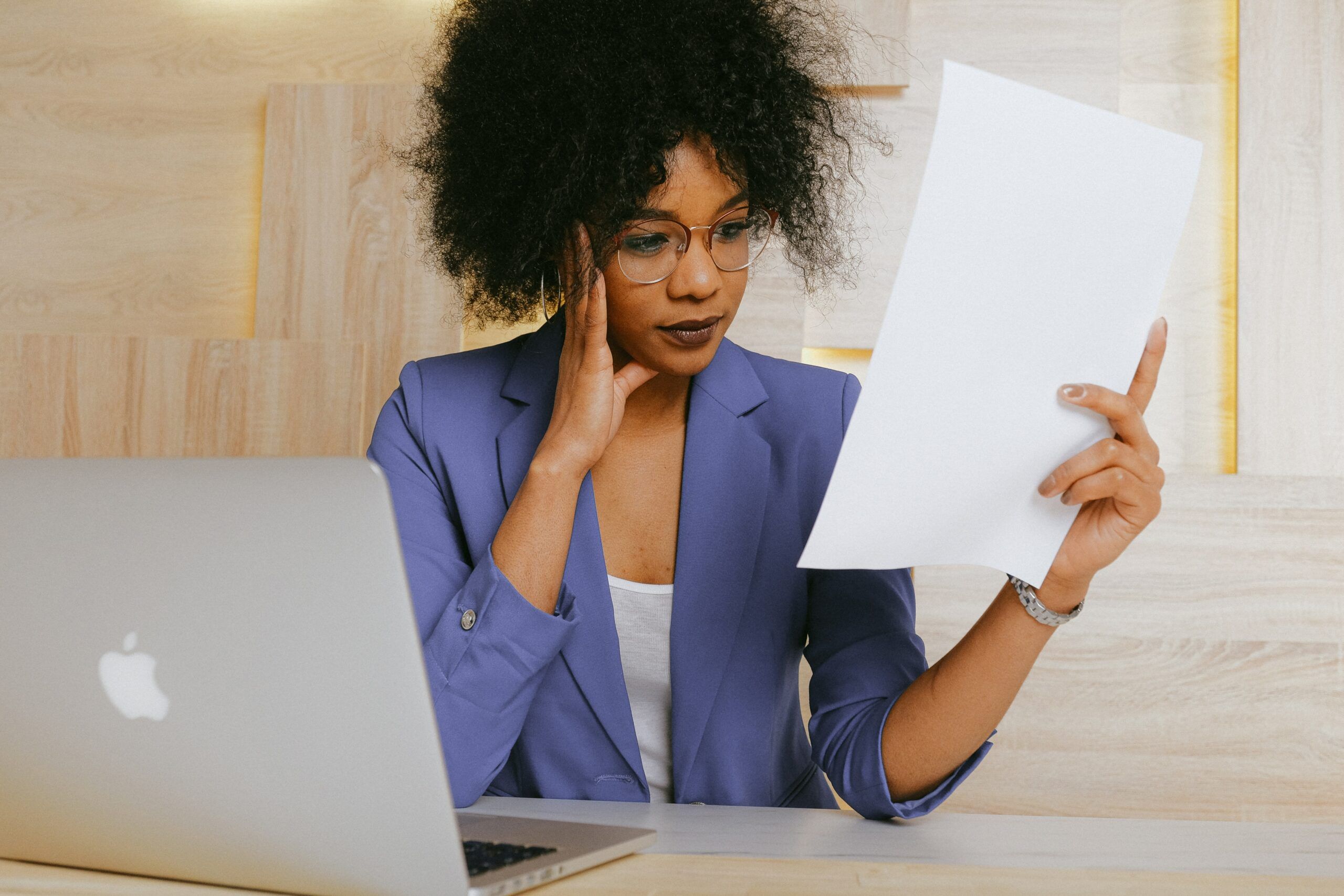 woman-in-blue-blazer-holding-white-paper-3727468